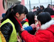 孩子们为志愿者系上红领巾